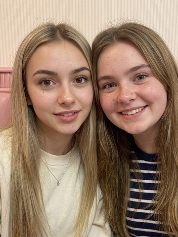 A favorite photo of two smiling sisters, ready to upload