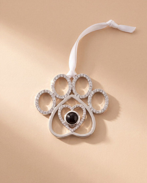 Crystal paw print photo ornament on a peach background