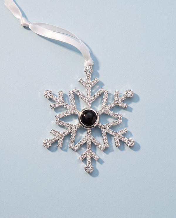 Crystal snowflake photo ornament on a pale blue background